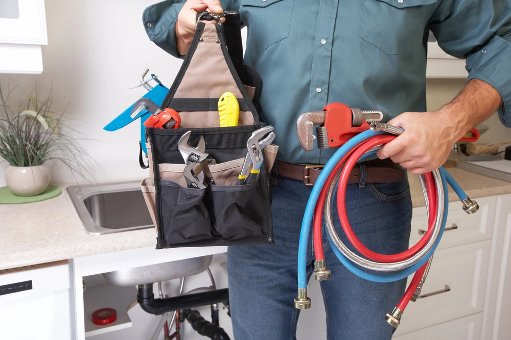 man bringing kitchen plumbing tools